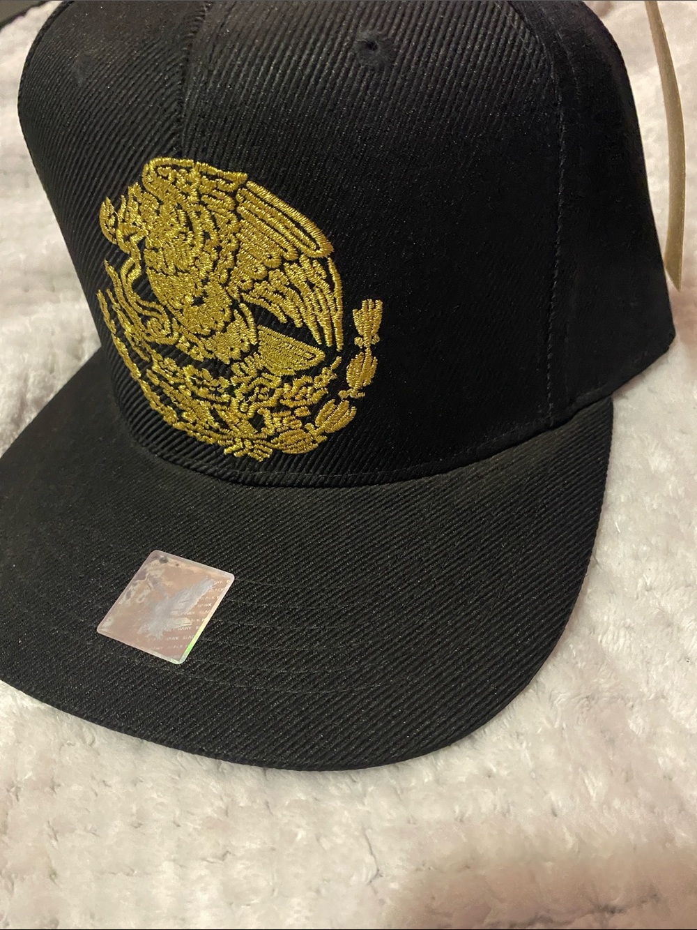Black Snapback Hat with Gold Embroidered Crest